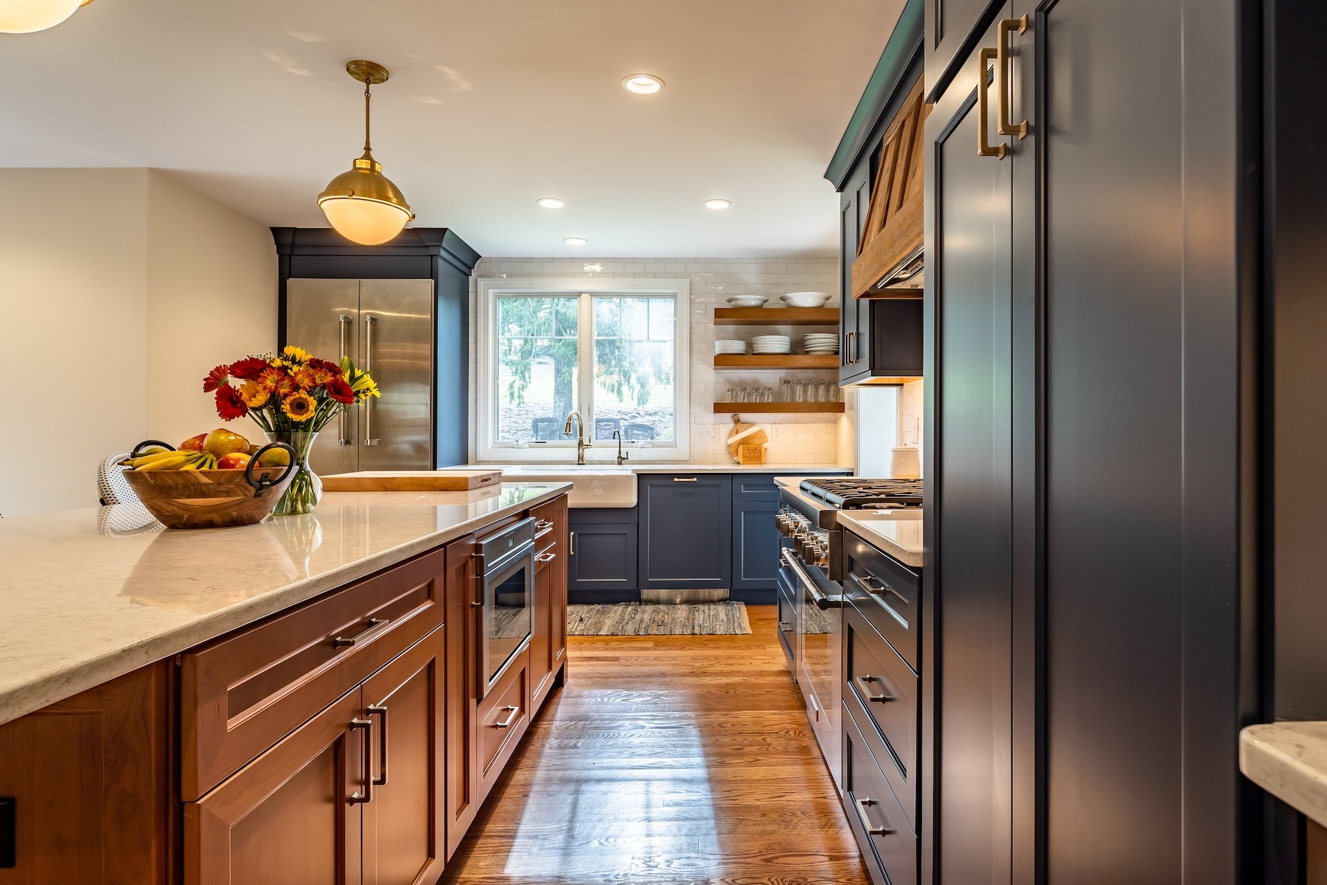 Kitchen with natural wood island and blue cabinets