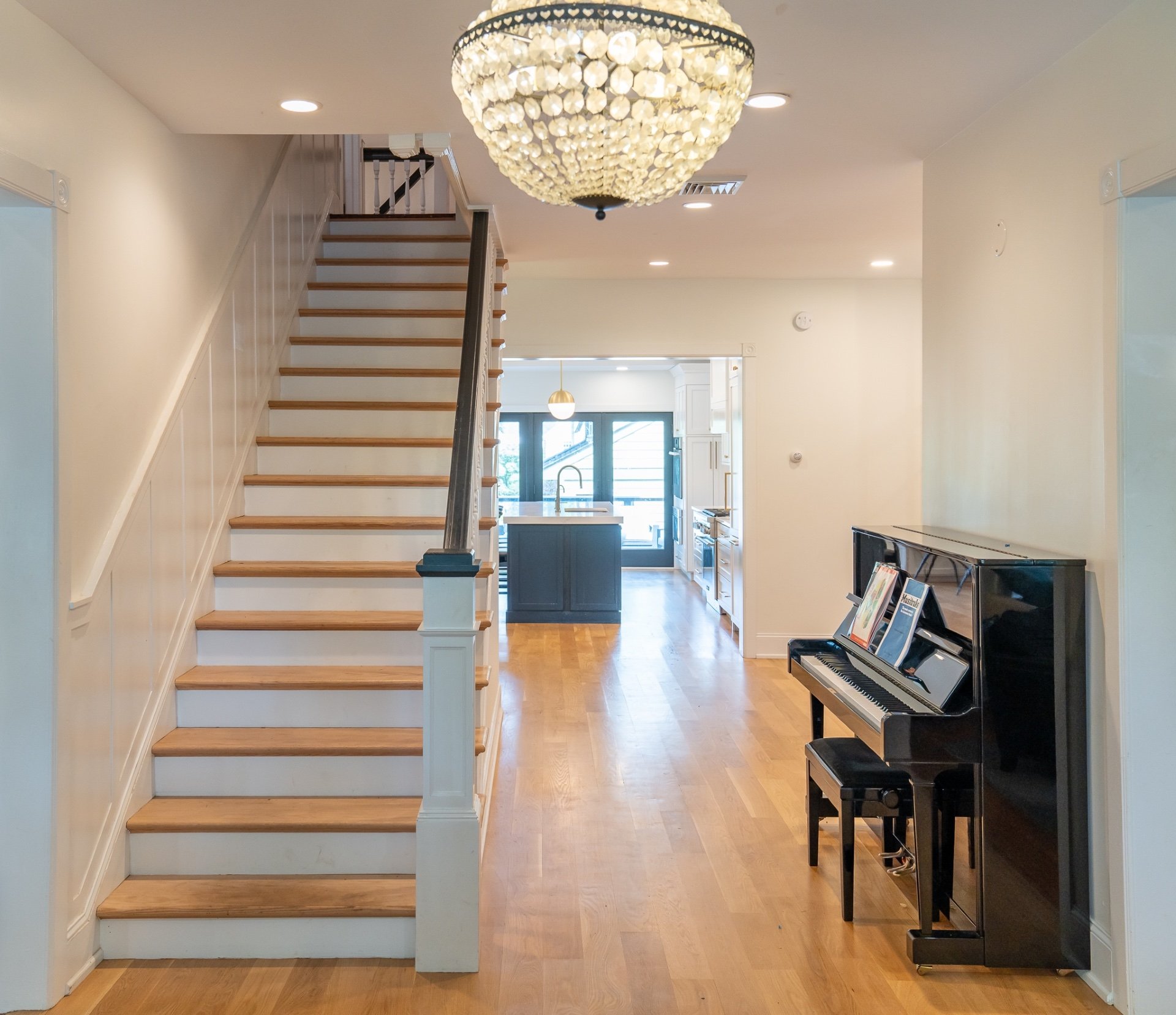 Restored hallway in classic home with upright piano
