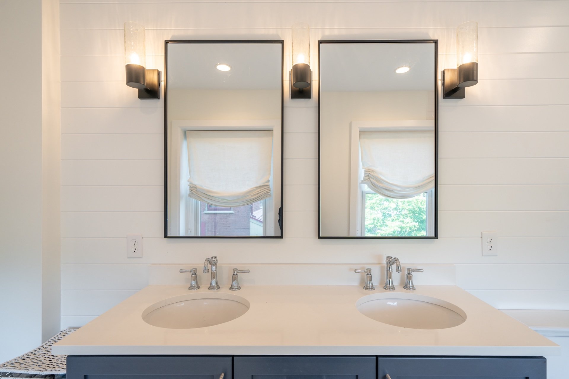 Two rectangular bathroom mirrors with black metal frames
