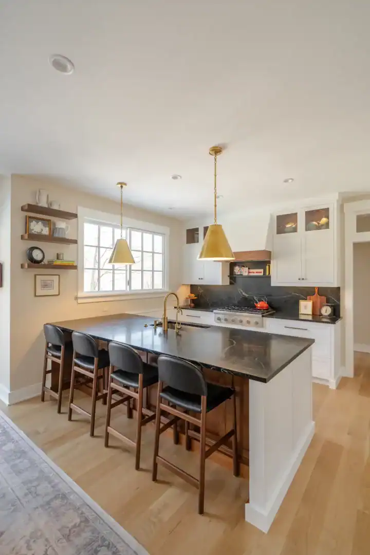 Remodeled kitchen with gold pendants