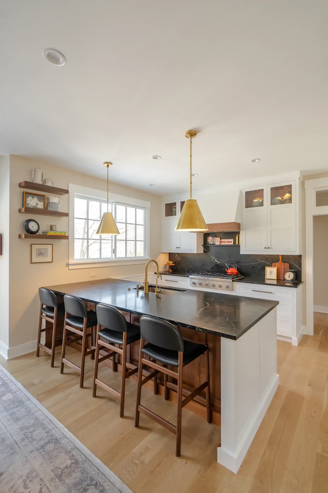 Remodeled kitchen with gold pendants