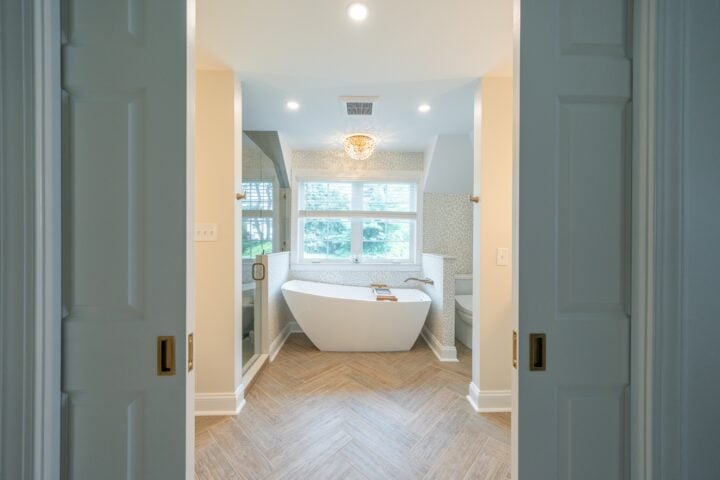 Soaking tub behind dual pocket doors