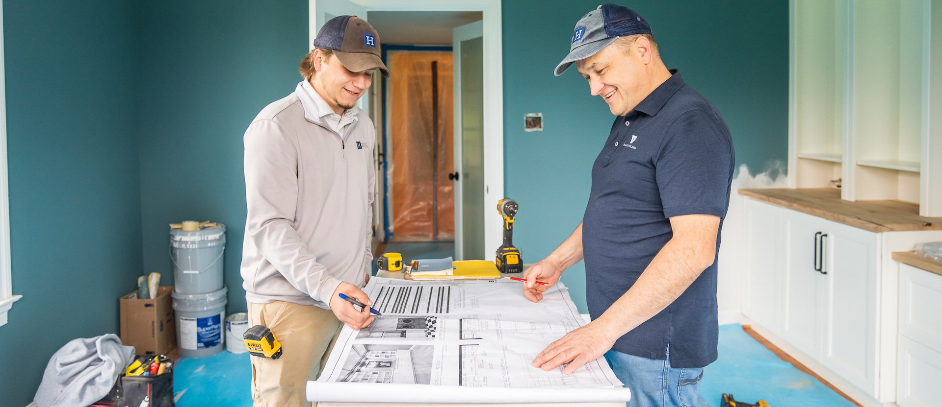 The Hazley Builders crew consulting plans at a home renovation jobsite