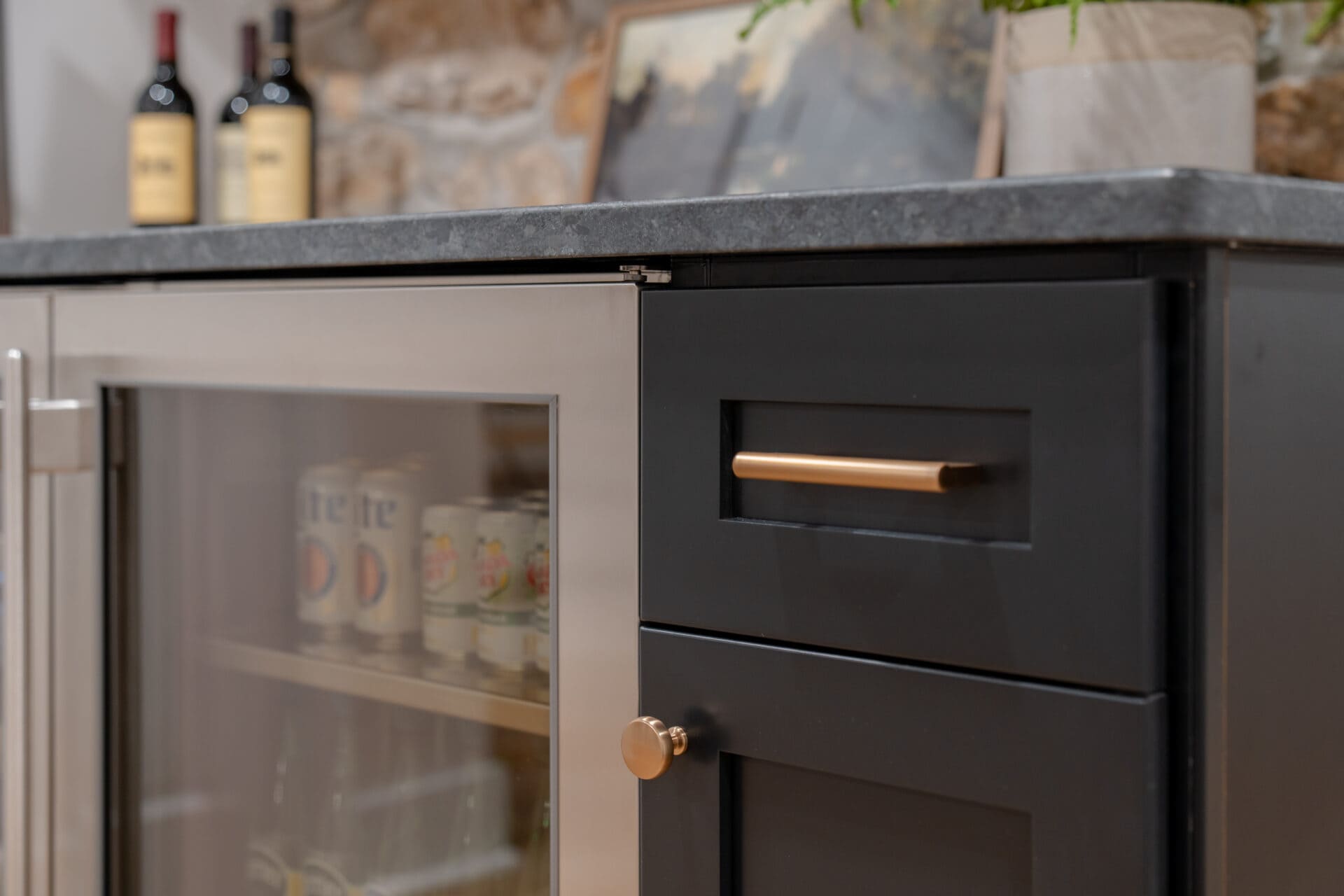 Closeup of beverage refrigerator in basement wet bar