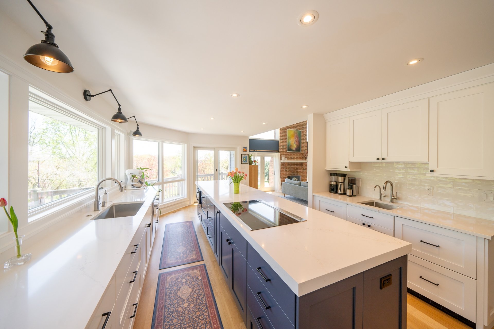 White and grey kitchen with large island with cooktop