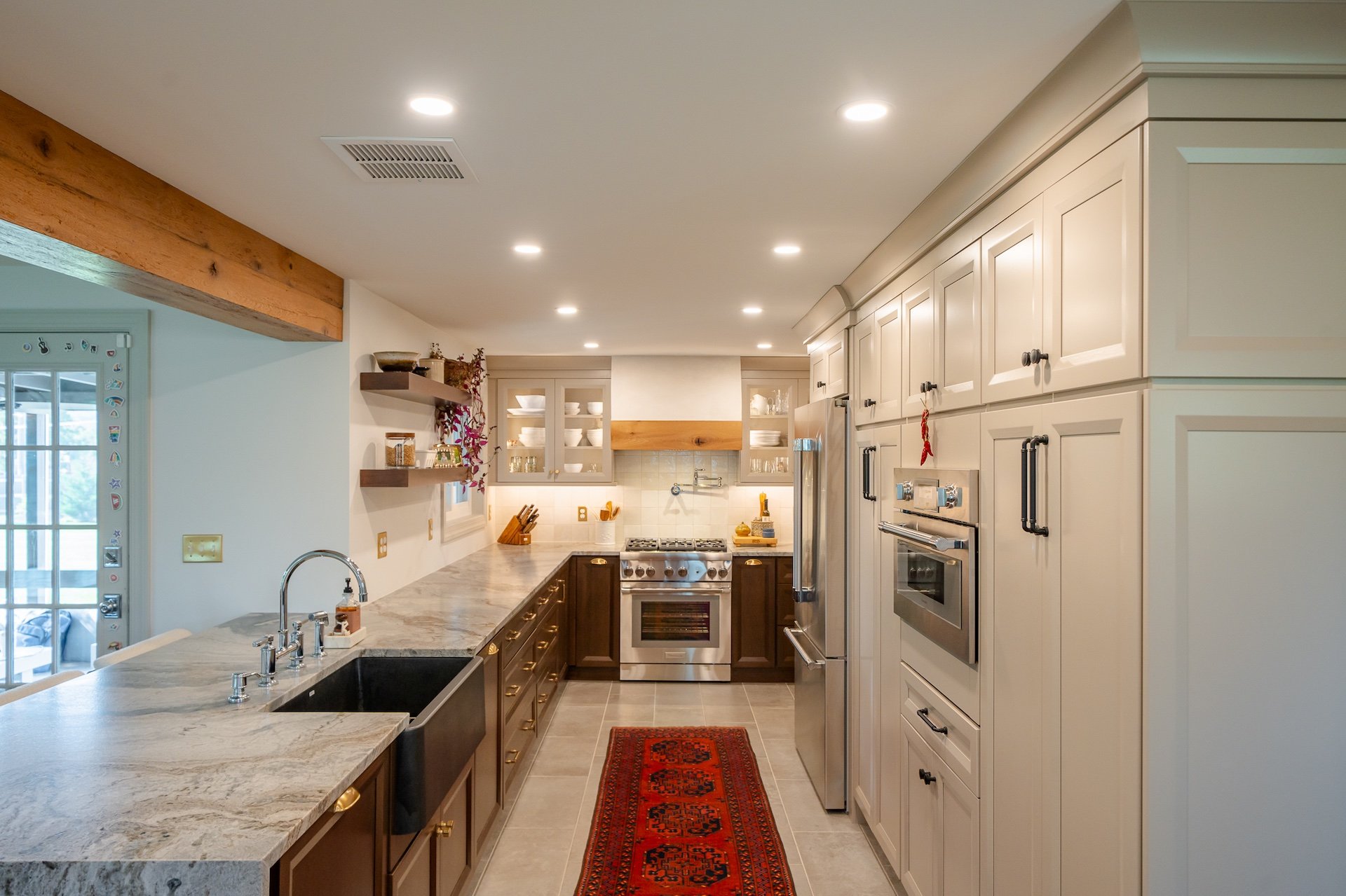 Galley style kitchen with dove grey cabinets and open countertop to dining room