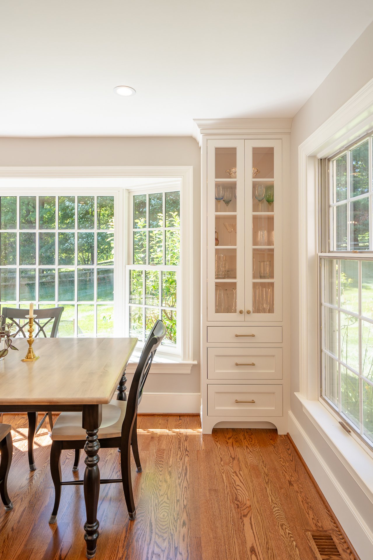 Classic window seat in dining room with built-ins surrounding it