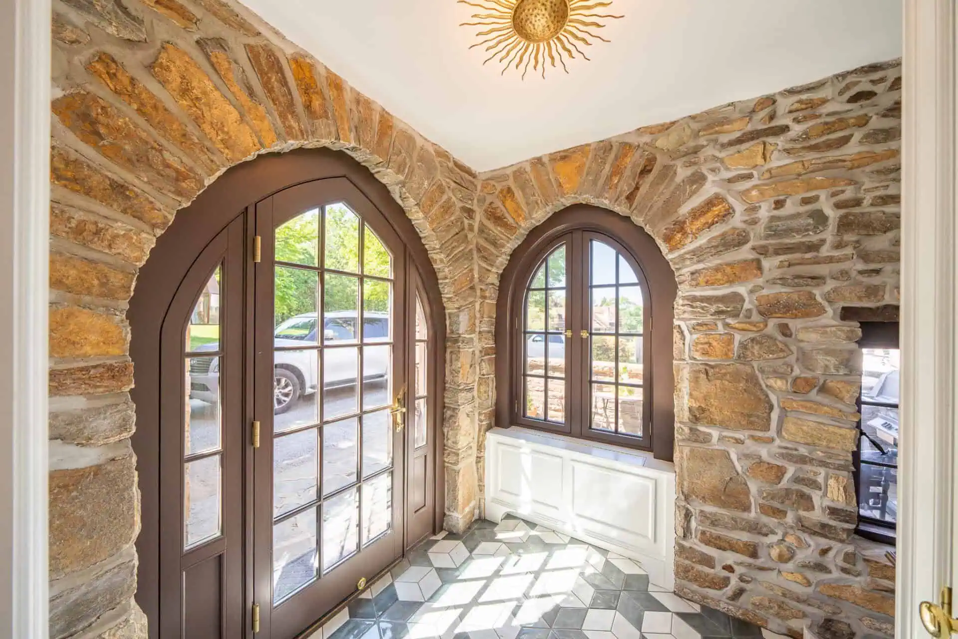 Arched wood door and window in entryway