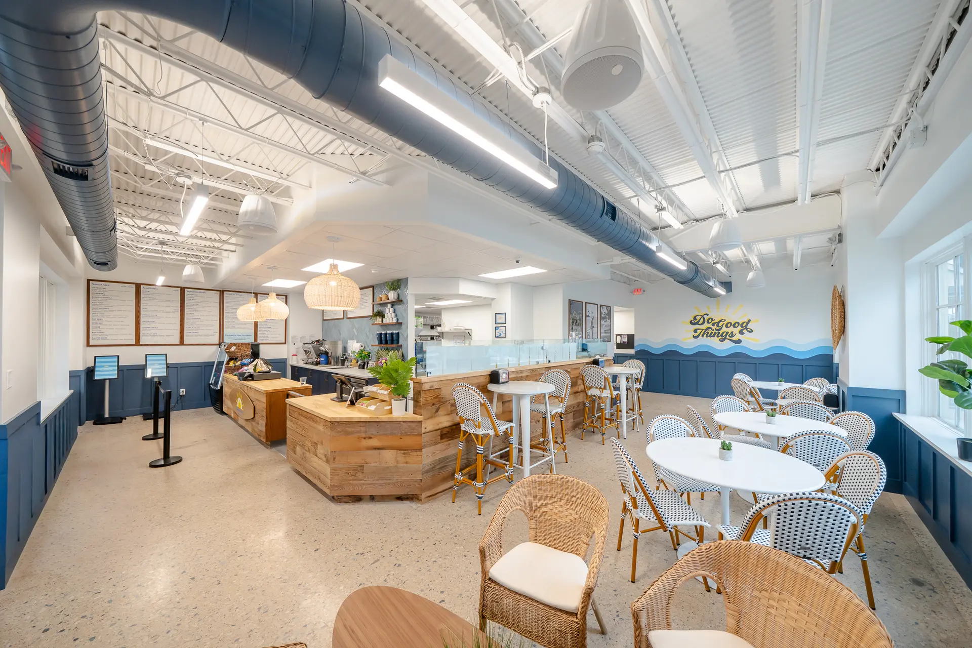 Finished Goodness Bowls dining area with exposed ductwork ceiling and custom wood service counter