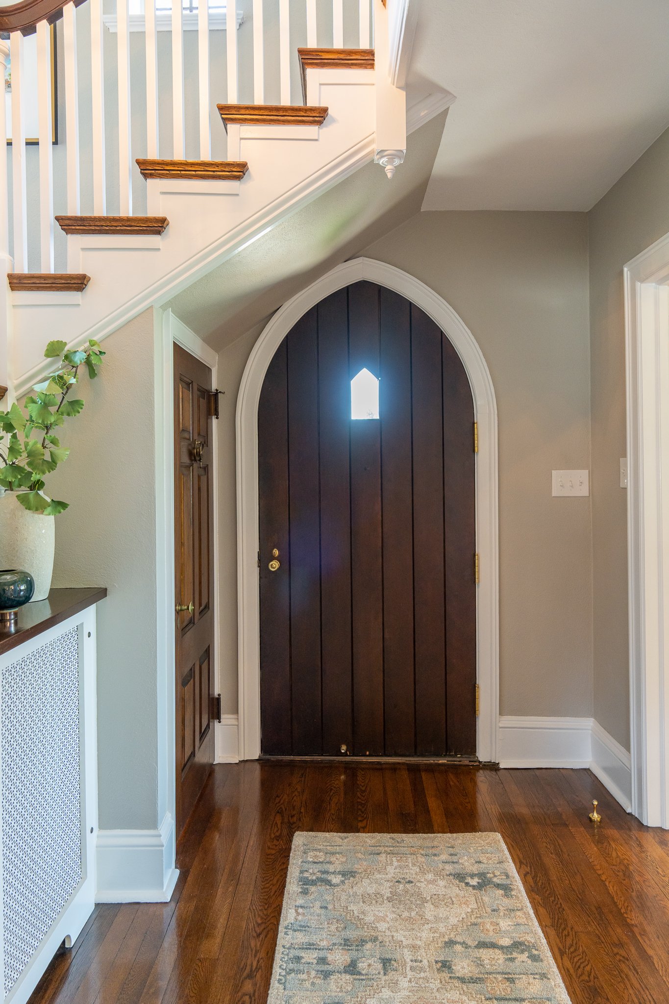 Classic dark wood paneled Tudor doorway with arched shape