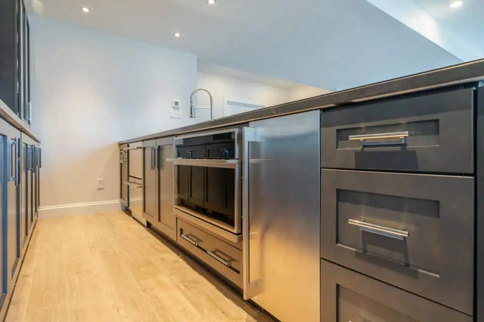 Contemporary kitchen cabinet section with stainless steel high-end appliances