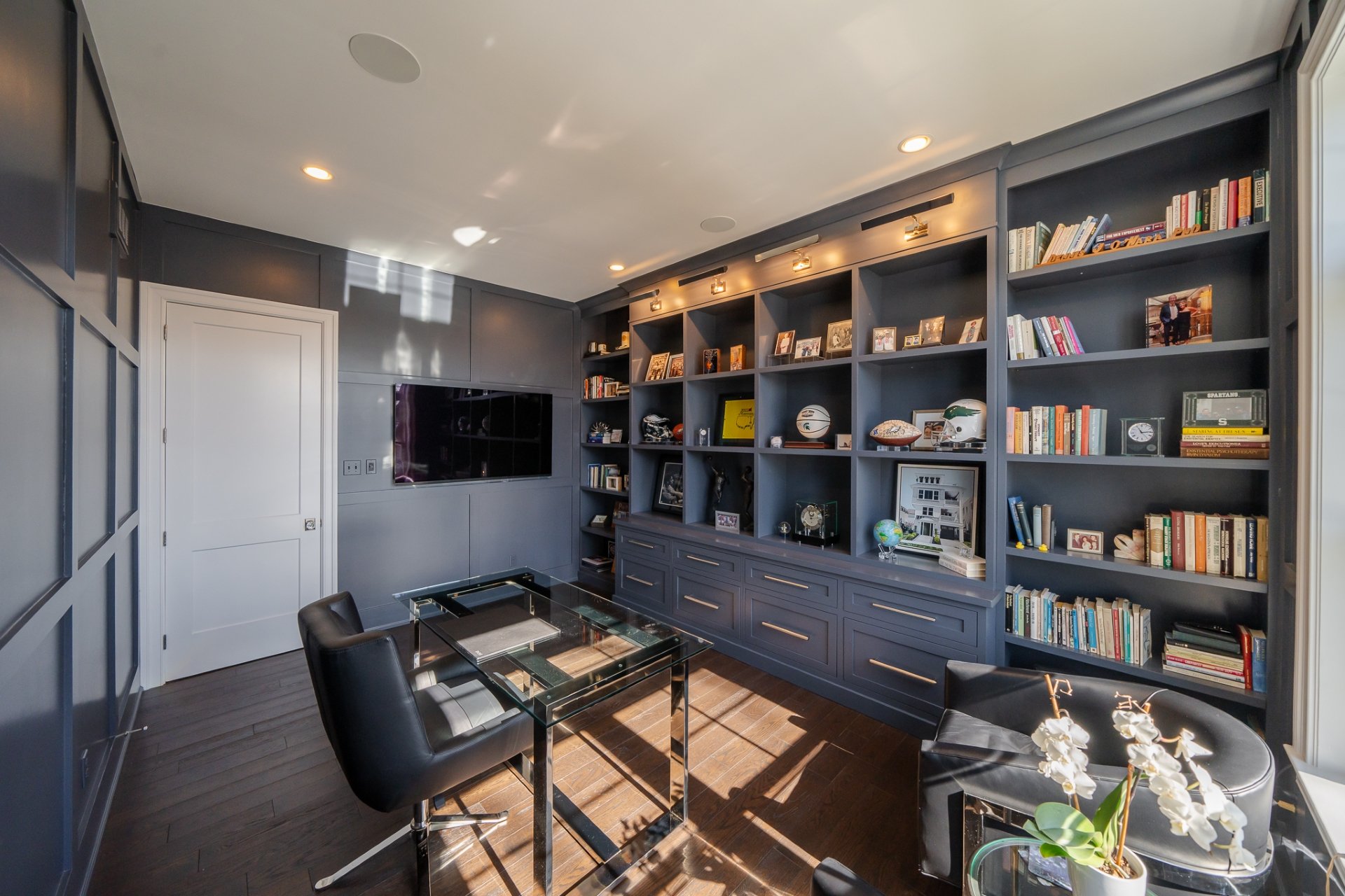 Home office with wall of built-in shelves