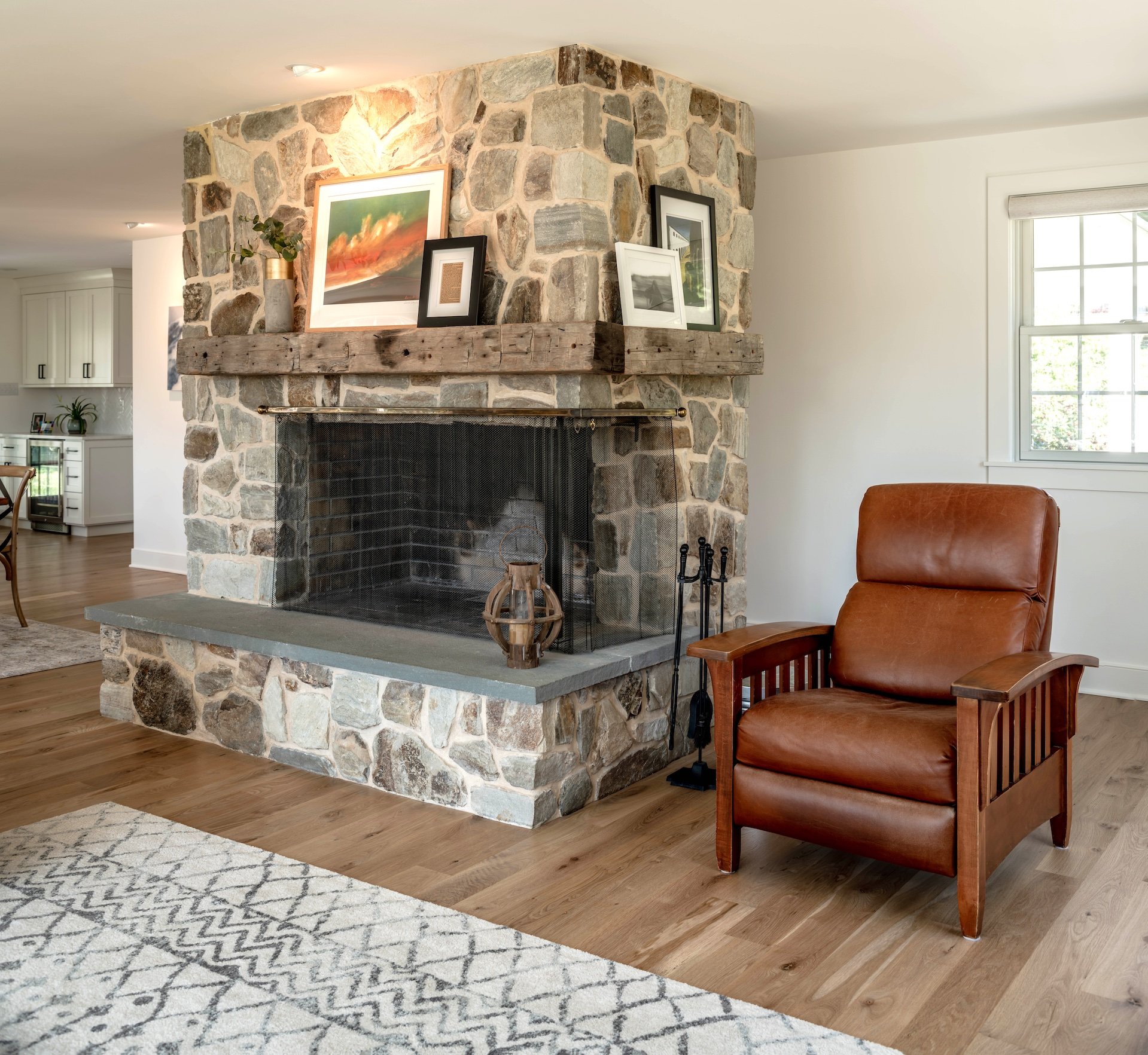 2025 Top Trends in Home Addition Design 5 Stone fireplace with wooden beams to hold up items