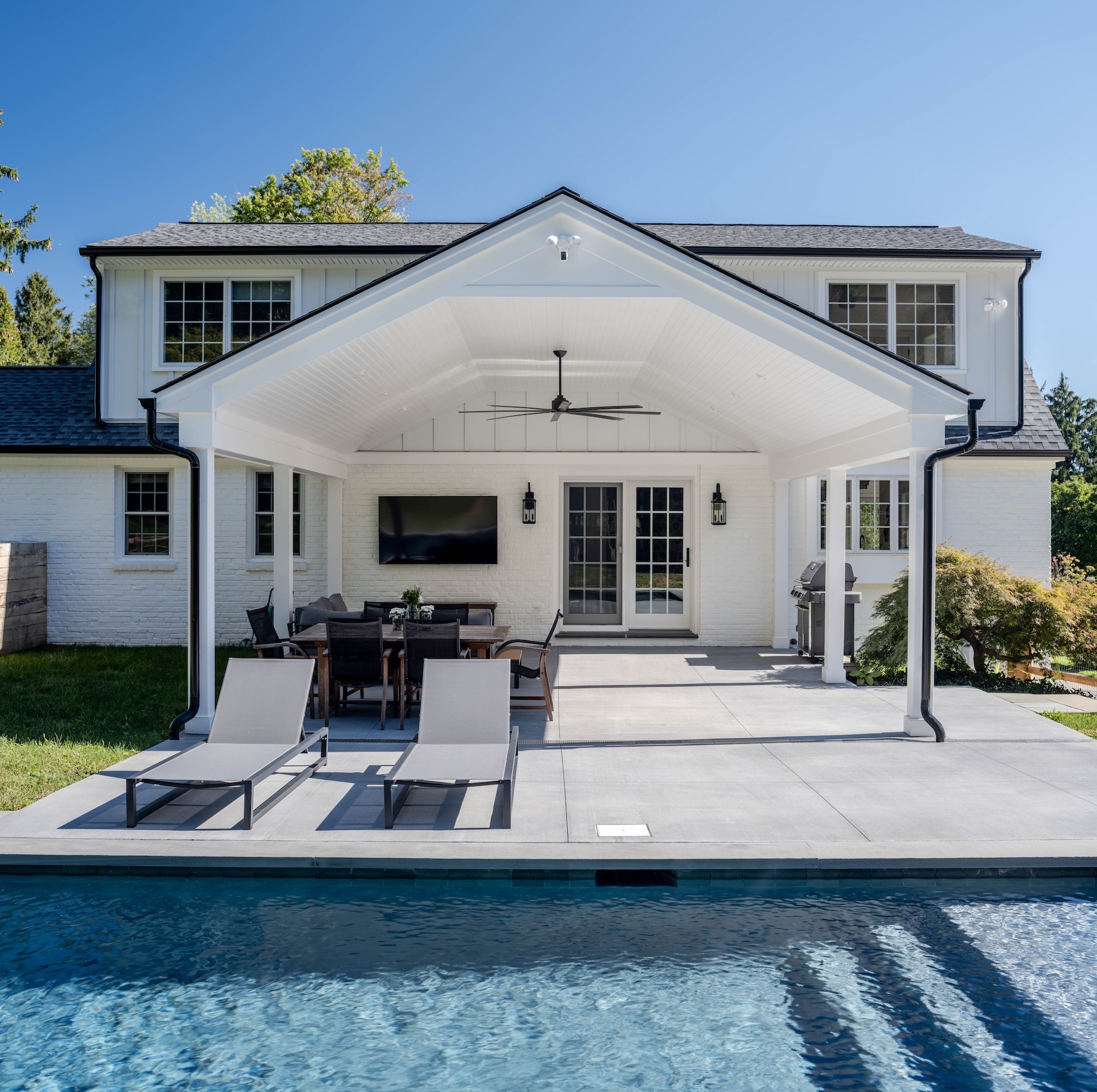 Home Remodeling Plans: How to Get Started on a Successful Project 1 a pool with chairs and a table in front of a house