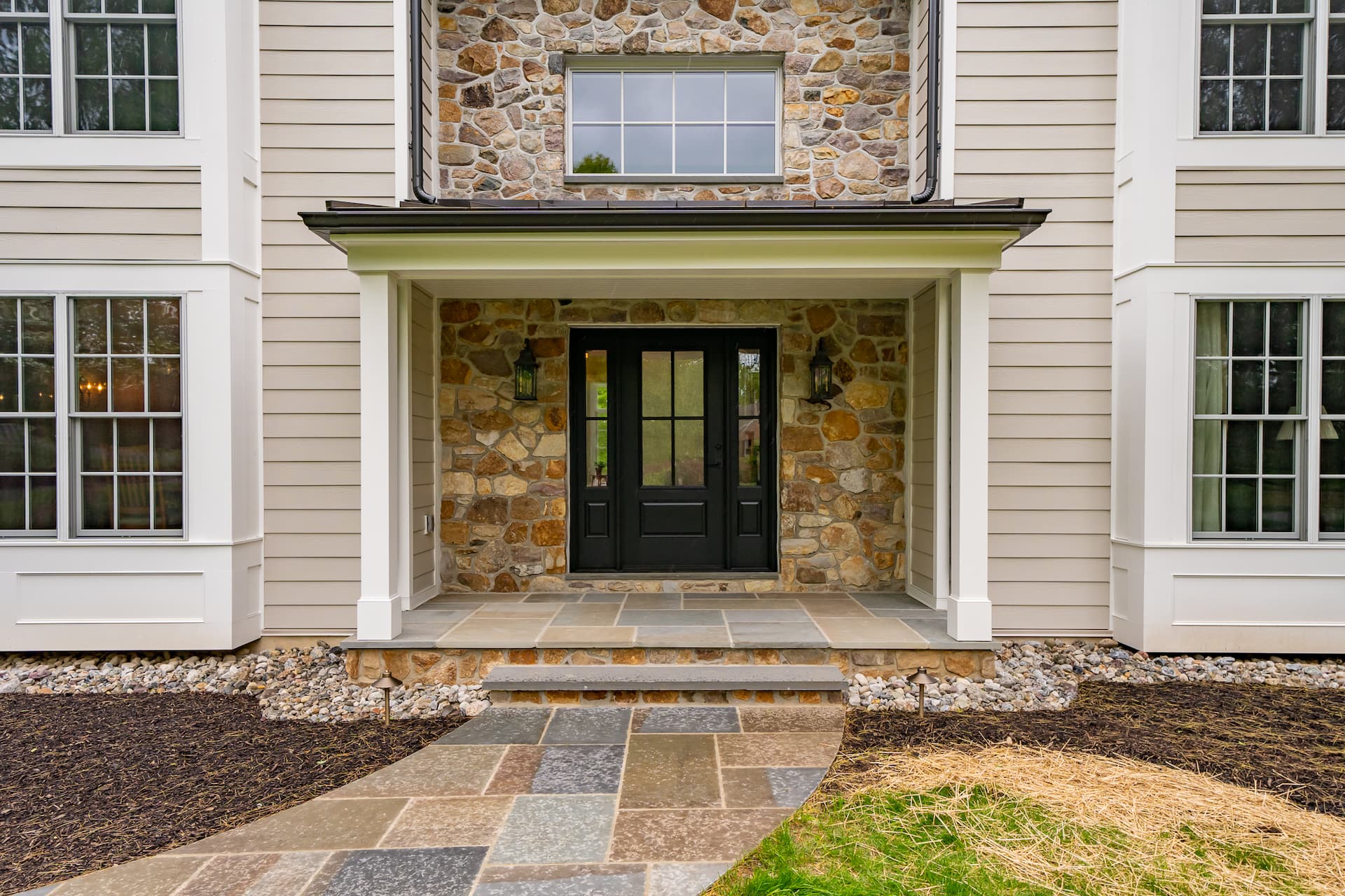 Exterior of Pennsylvania home with grand rock-faced entrance