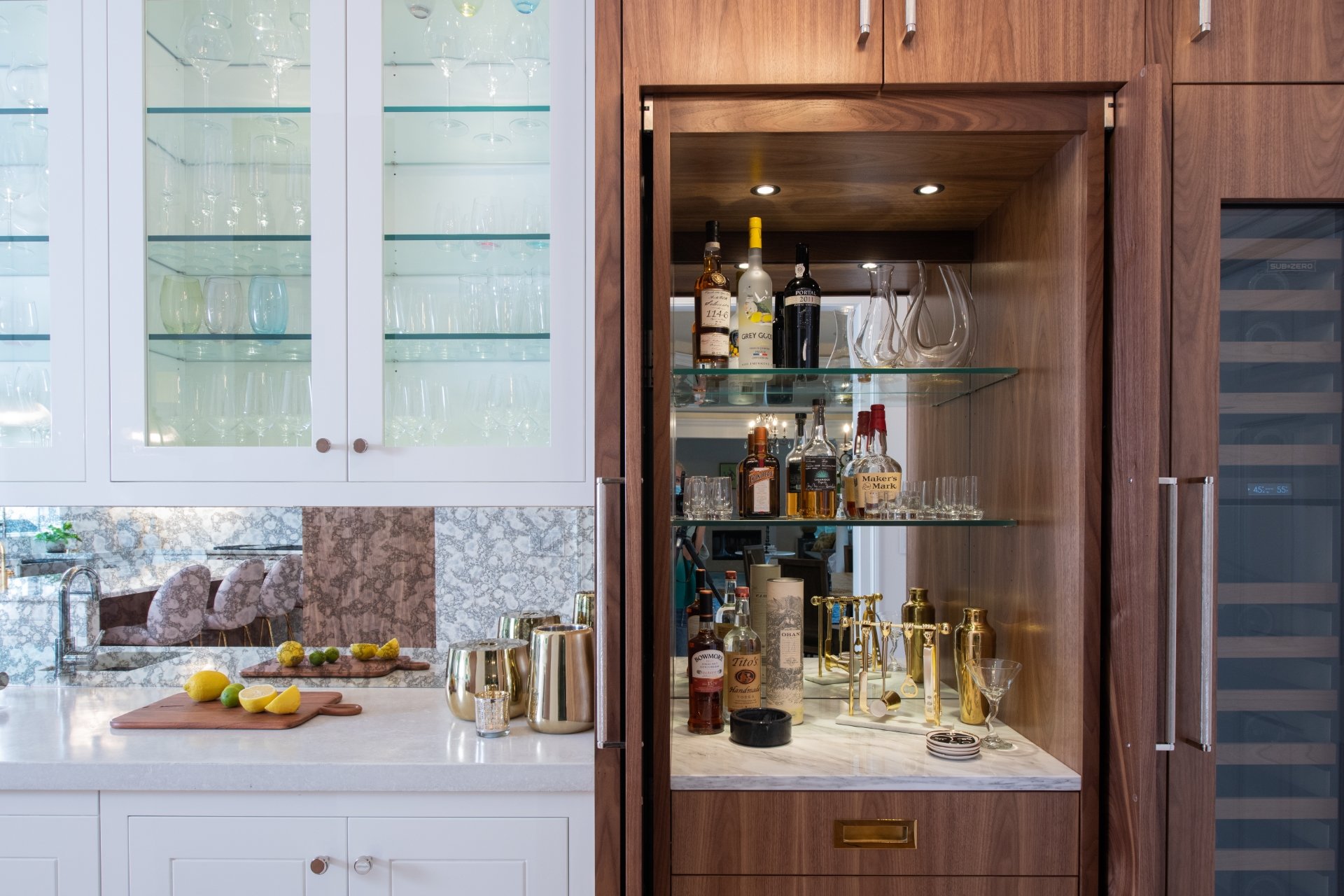 Hidden bar in custom walnut cabinets