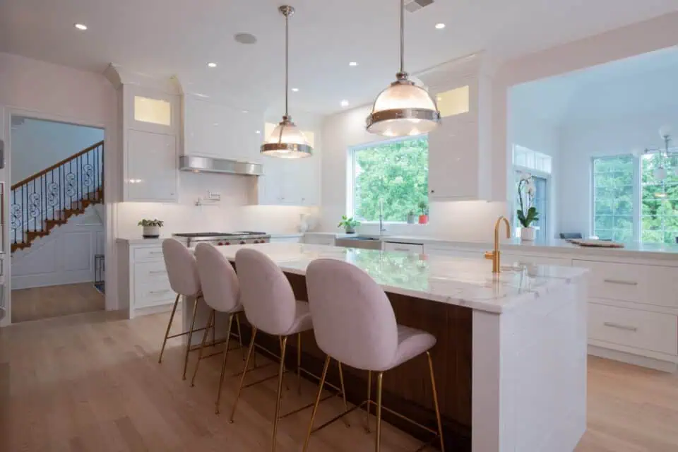 Remodeled kitchen island with pendant lighting and wood floor