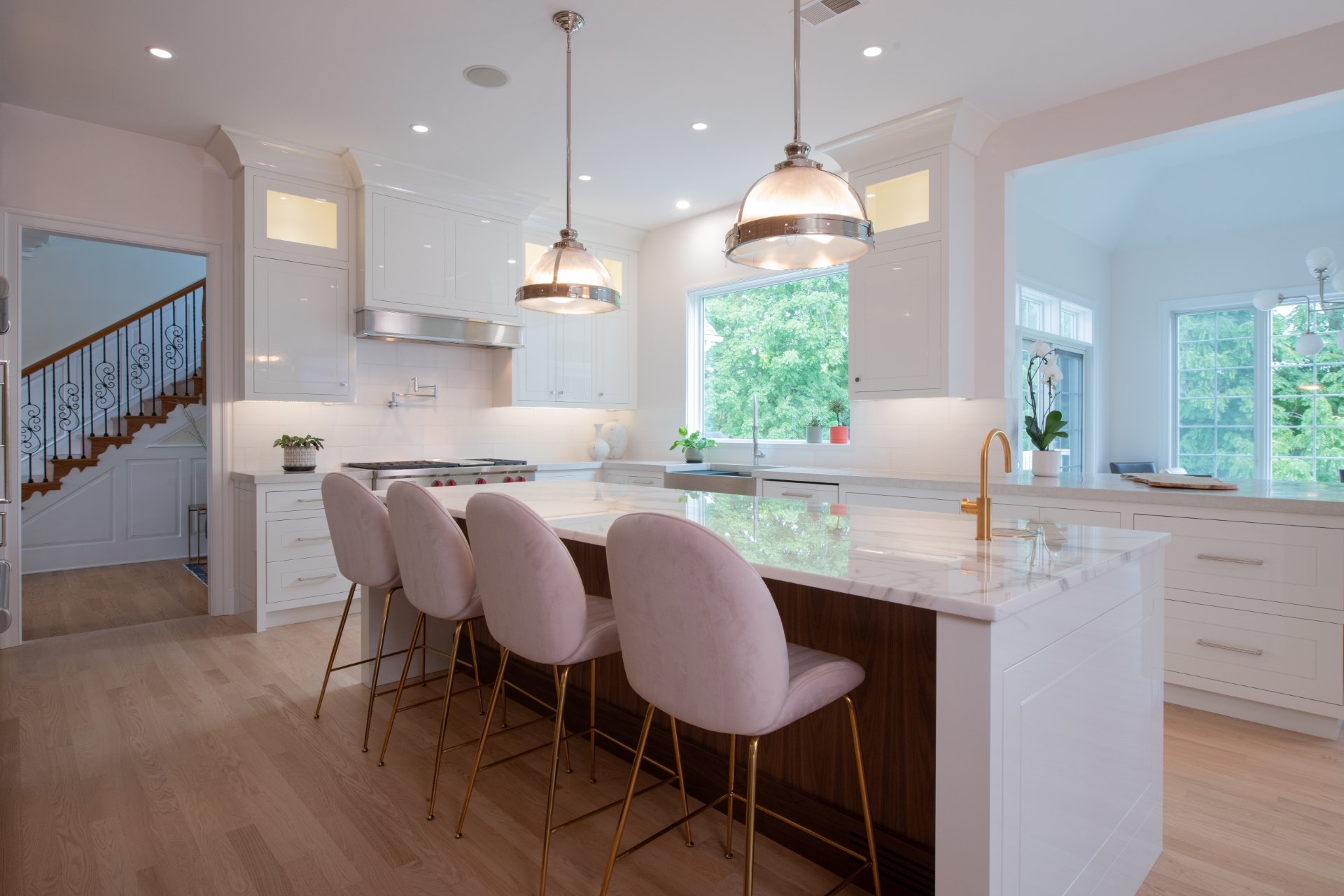 Remodeled kitchen island with pendant lighting and wood floor