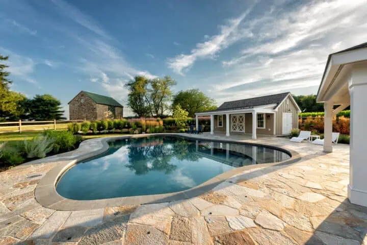 Pool house aside an oblong-shaped pool in Chester County, PA