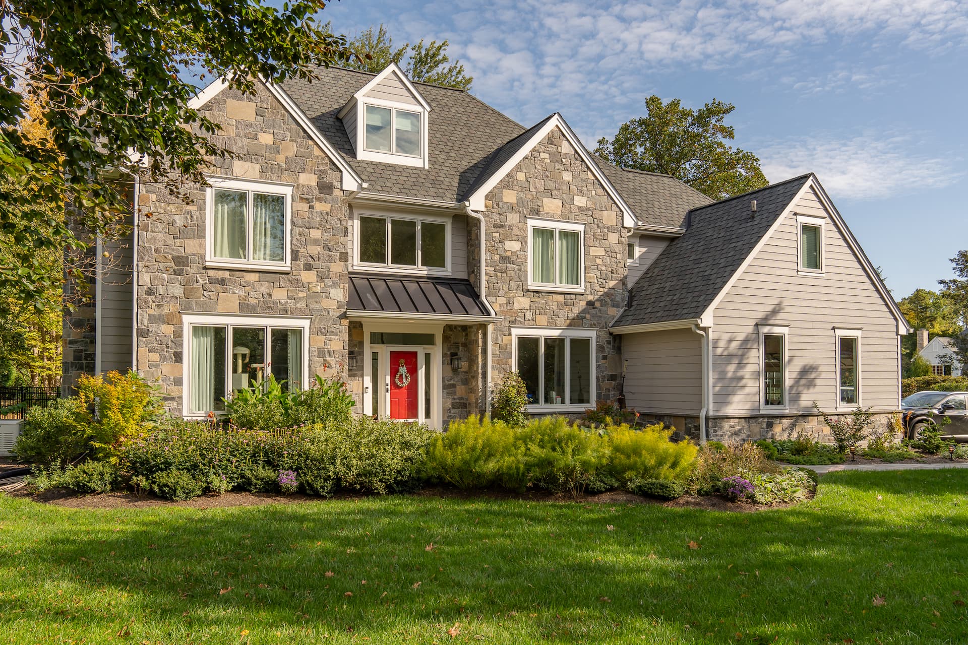 Exterior of brick home in the West Chester PA area, red door