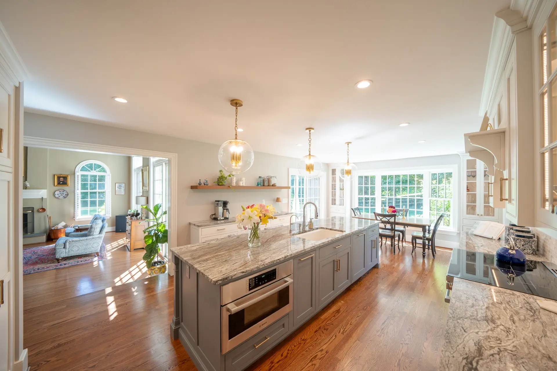 Open-concept kitchen layout with luxury lighting