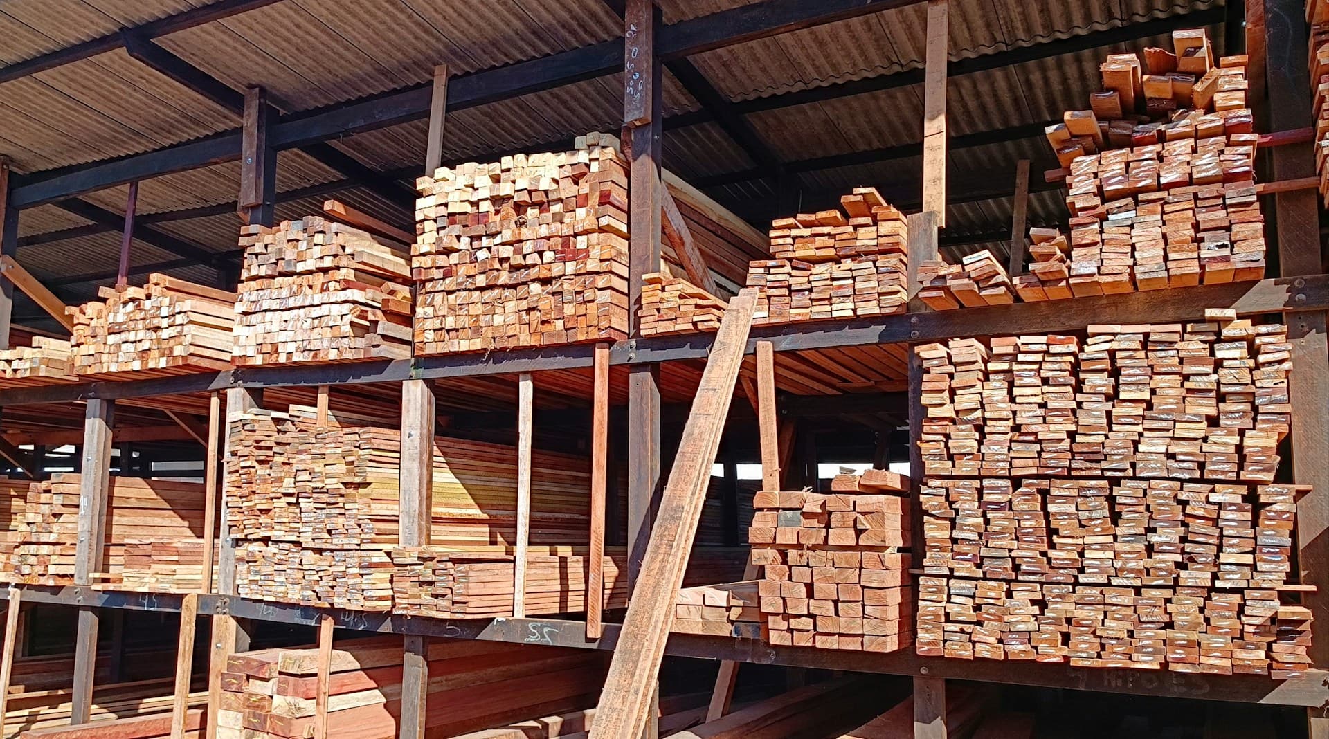 Lumber stacked in a storage warehouse - tariffs and remodeling