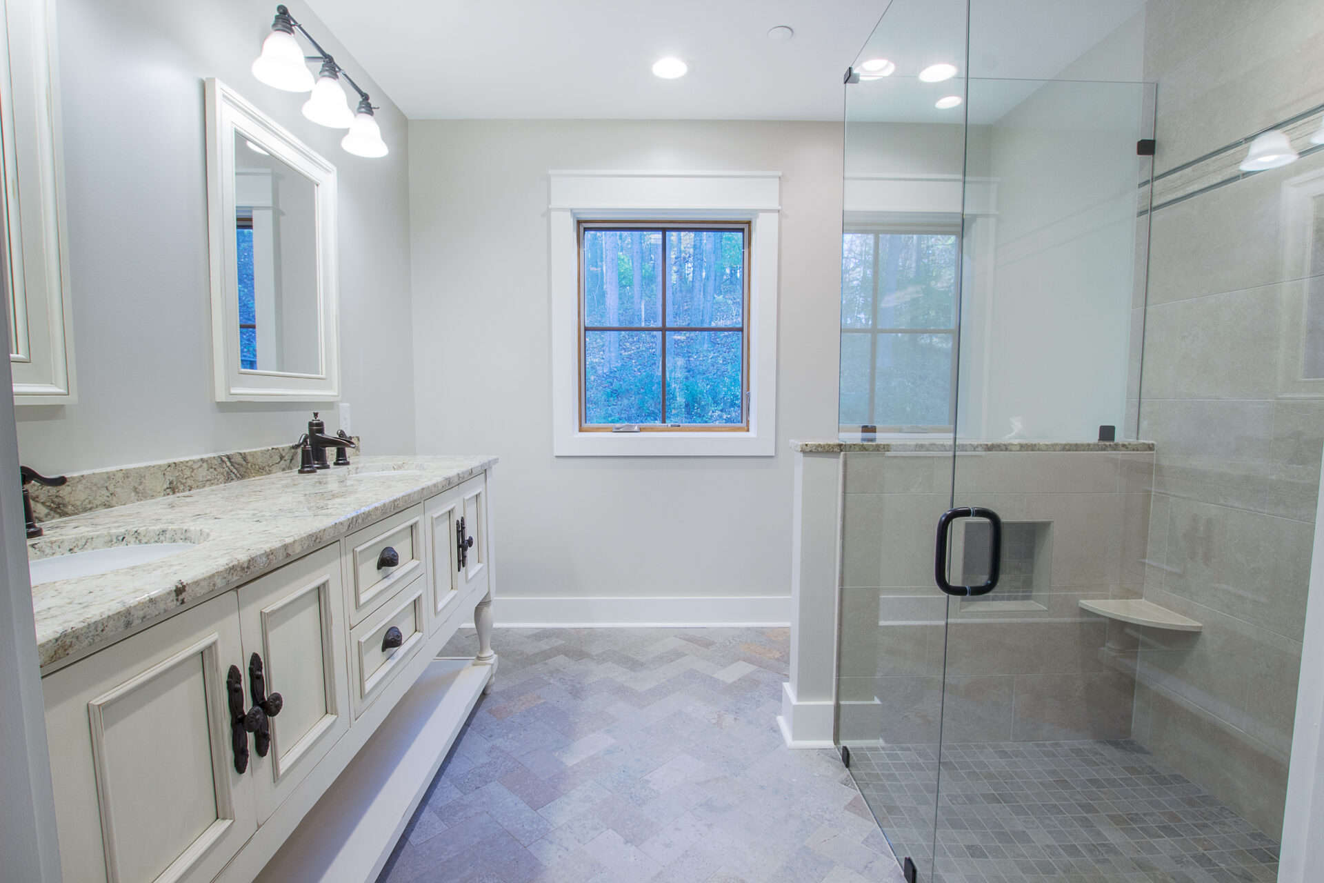 Remodeled bathroom located in Chester County, PA, with curbless shower that has a glass surround
