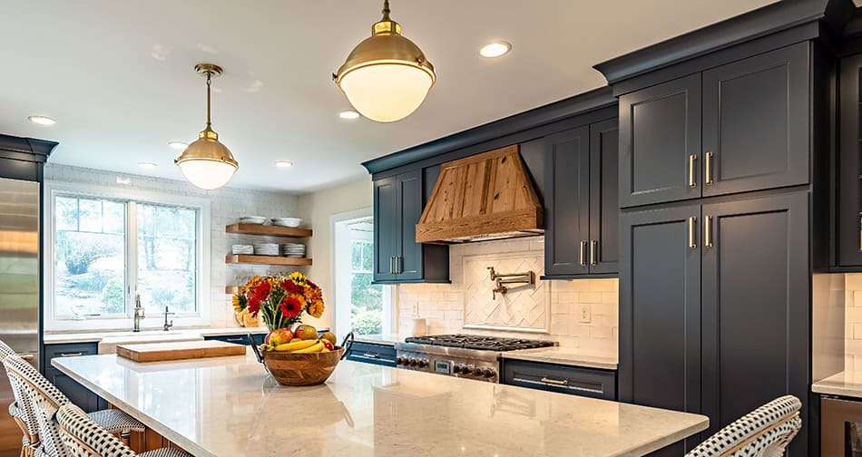 Kitchen with dark blue cabinets and gold cabinet pulls