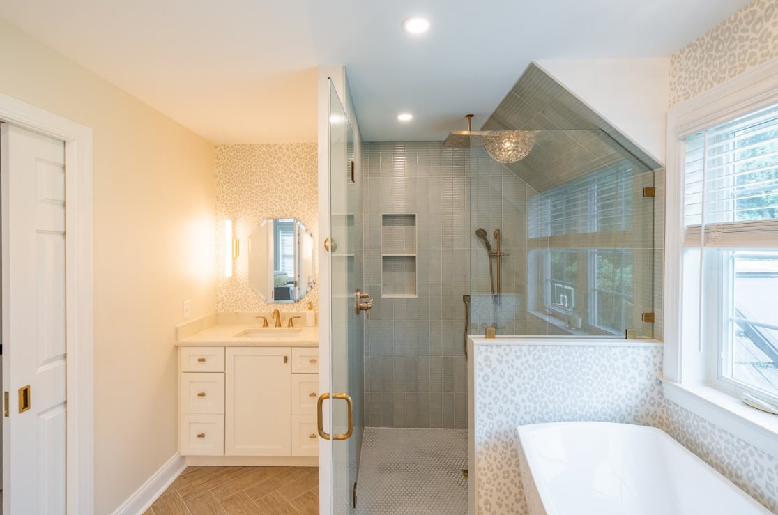 A bathroom with two distinct tile patterns - lined and spotted